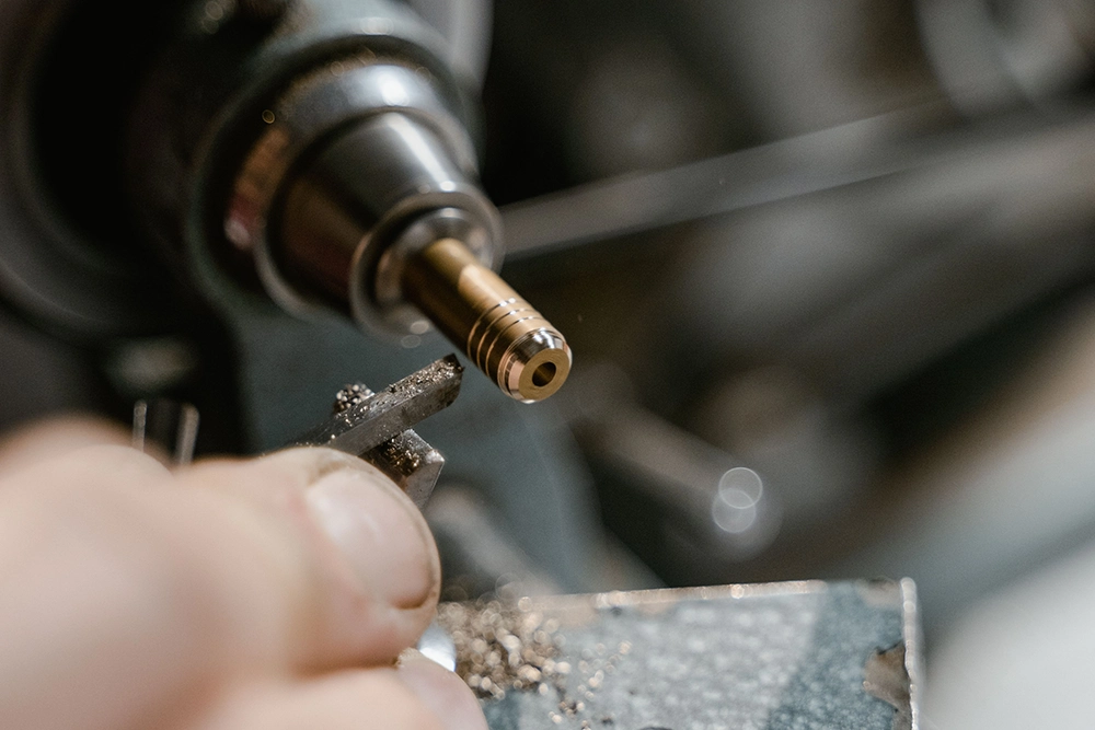 CNC turning a small brass component on a lathe